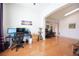 Open-concept living area with hardwood floors and ample space for multiple workstations at 3696 Waynesvill St, Las Vegas, NV 89122