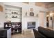 Cozy living room with a fireplace, built-in bar with glass shelving at 3696 Waynesvill St, Las Vegas, NV 89122