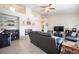 Spacious living room with a fireplace, wet bar, ceiling fan, and tile flooring at 3696 Waynesvill St, Las Vegas, NV 89122