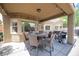 Covered patio with a circular table, seating for six, and a built-in barbecue grill at 3696 Waynesvill St, Las Vegas, NV 89122
