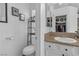 Bathroom featuring toilet, sink with granite countertop and mirror at 3741 Round Robin St, North Las Vegas, NV 89032