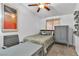 This is a bright bedroom with a ceiling fan and a painting in the wall at 3741 Round Robin St, North Las Vegas, NV 89032