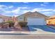 Charming single-story home featuring a well-manicured lawn, a two-car garage, and a welcoming facade at 3741 Round Robin St, North Las Vegas, NV 89032