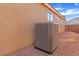 Side exterior view of the property showcasing the AC unit in a low-maintenance backyard at 3741 Round Robin St, North Las Vegas, NV 89032