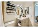 Nicely appointed bathroom with updated vanity and round mirror features a warm and inviting design at 4338 Caliente St # 11, Las Vegas, NV 89119