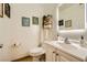 This bathroom has a toilet, sink, mirror, artwork and decorative shelving at 4338 Caliente St # 11, Las Vegas, NV 89119
