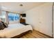 Bedroom with wood floors features a television and ample natural light from a large window at 4338 Caliente St # 11, Las Vegas, NV 89119