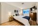 This bedroom boasts wood floors, a television, and a well-lit window for a comfortable space at 4338 Caliente St # 11, Las Vegas, NV 89119