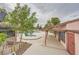 Community pool with mature landscaping, adjacent spa, and covered walkway to a nearby building at 4338 Caliente St # 11, Las Vegas, NV 89119