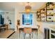 Bright dining area features a modern light fixture, decorative shelving and tile floors at 4338 Caliente St # 11, Las Vegas, NV 89119