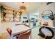 Dining area boasts a modern light fixture, decorative shelving and is adjacent to the kitchen at 4338 Caliente St # 11, Las Vegas, NV 89119