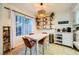 This dining area features a modern light fixture, shelving, tile floors and a coffee bar at 4338 Caliente St # 11, Las Vegas, NV 89119