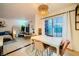 View of the dining area with a modern light fixture, tile floors and view into living room at 4338 Caliente St # 11, Las Vegas, NV 89119