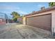 Building exterior featuring multiple garage doors with a parking area at 4338 Caliente St # 11, Las Vegas, NV 89119