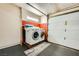 Laundry area in the garage, featuring a washer and dryer with a utility sink at 4338 Caliente St # 11, Las Vegas, NV 89119