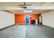 Open garage interior with tile flooring, accent wall, and water heater at 4338 Caliente St # 11, Las Vegas, NV 89119
