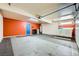Spacious garage featuring tile flooring, bright lighting, and a vibrant accent wall at 4338 Caliente St # 11, Las Vegas, NV 89119