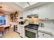 Efficient kitchen layout with stainless steel appliances, overhead lighting, and adjacent dining area at 4338 Caliente St # 11, Las Vegas, NV 89119