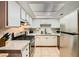Well-lit kitchen equipped with stainless steel appliances, bright white cabinets and tiled floors at 4338 Caliente St # 11, Las Vegas, NV 89119