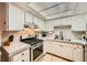 Bright kitchen featuring stainless steel appliances, white cabinets and ample counter space at 4338 Caliente St # 11, Las Vegas, NV 89119