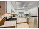 Well-equipped kitchen boasting stainless steel appliances, white cabinets and tiled floors at 4338 Caliente St # 11, Las Vegas, NV 89119