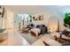 Inviting living room with modern decor, a staircase, stylish grey couch and a large mirror at 4338 Caliente St # 11, Las Vegas, NV 89119