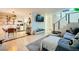 Open-concept living space with a modern couch, floating stairs and adjacent kitchen and dining area at 4338 Caliente St # 11, Las Vegas, NV 89119