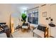 A cozy living room featuring stylish chairs, a trendy mirror and a view to the outside at 4338 Caliente St # 11, Las Vegas, NV 89119