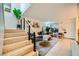 Bright living room features hardwood stairs, a large plant and an area rug at 4338 Caliente St # 11, Las Vegas, NV 89119