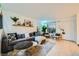 Bright living room featuring a comfortable gray couch, stylish coffee tables and tiled floors at 4338 Caliente St # 11, Las Vegas, NV 89119