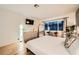 Bright main bedroom has wood floors, a full sized bed and a large window at 4338 Caliente St # 11, Las Vegas, NV 89119