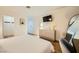 Bright main bedroom featuring wood-look floors, television, accent art, and neutral colors at 4338 Caliente St # 11, Las Vegas, NV 89119