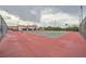 Outdoor tennis court on a partly cloudy day with view of adjacent property and ample lighting at 4338 Caliente St # 11, Las Vegas, NV 89119
