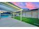 Backyard featuring covered patio, artificial turf, landscaping and block wall. Ideal for outdoor enjoyment and privacy at 4623 Kearney St, Las Vegas, NV 89147
