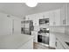 Modern kitchen featuring stainless steel appliances, a kitchen island, and light fixtures at 4623 Kearney St, Las Vegas, NV 89147