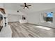 Bright living room features gray flooring, a brick fireplace, and an open view to the kitchen at 4623 Kearney St, Las Vegas, NV 89147