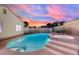 Backyard pool and jacuzzi feature tiled trim and concrete surround, perfect for relaxation under vibrant twilight sky at 4623 Kearney St, Las Vegas, NV 89147