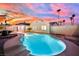 Inviting backyard pool with clear water, surrounded by decorative concrete and enhanced by a colorful twilight sky at 4623 Kearney St, Las Vegas, NV 89147