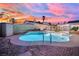 Backyard pool and jacuzzi feature tiled trim and concrete surround, perfect for relaxation under vibrant twilight sky at 4623 Kearney St, Las Vegas, NV 89147