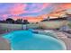 Backyard pool and jacuzzi feature tiled trim and concrete surround, perfect for relaxation under vibrant twilight sky at 4623 Kearney St, Las Vegas, NV 89147