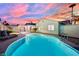 Inviting backyard pool with clear water, surrounded by decorative concrete and enhanced by a colorful twilight sky at 4623 Kearney St, Las Vegas, NV 89147