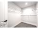 Walk-in closet with custom shelving and gray carpeting at 4774 San Sebastian Ave, Las Vegas, NV 89121