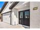The front of the home features a two-car garage and stylish front doors with decorative glass and the house number at 4774 San Sebastian Ave, Las Vegas, NV 89121