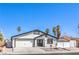 Charming single-story home featuring a two-car garage, palm trees, desert landscaping, and a white stucco facade at 4774 San Sebastian Ave, Las Vegas, NV 89121