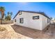 Exterior home view with white walls, black trim, and a spacious backyard at 4774 San Sebastian Ave, Las Vegas, NV 89121