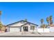 Charming single-story home featuring a two-car garage, palm trees, desert landscaping, and a white stucco facade at 4774 San Sebastian Ave, Las Vegas, NV 89121