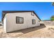 Exterior view showing a white home with black trim and a block wall fence at 4774 San Sebastian Ave, Las Vegas, NV 89121