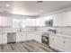 Stylish kitchen with stainless steel appliances, white cabinets, and marble countertops at 4774 San Sebastian Ave, Las Vegas, NV 89121