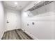 A well-lit laundry room with wood-look floors and a wire shelf above the water hookups at 4774 San Sebastian Ave, Las Vegas, NV 89121