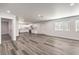Spacious living room boasts updated flooring, recessed lighting, and an open layout to the kitchen and dining area at 4774 San Sebastian Ave, Las Vegas, NV 89121